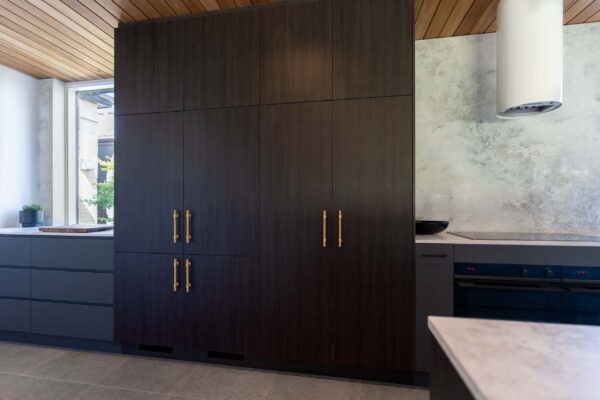 Kitchen pantry Cabinets in Laminex burnished wood, a deep warm brown with heavy duty brass handles.