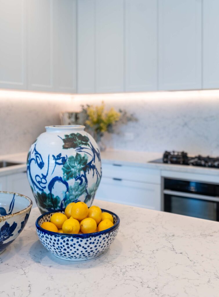 Vibrant and well styled blue pots sit proud on the grey organic benchtop.