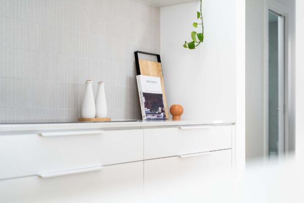 Kitchen styling with slim line white draws and kit kat splashback.