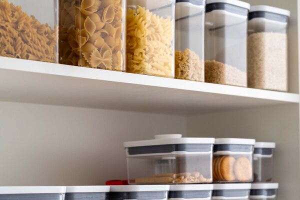 Open pantry organisation. pantry containers well placed and stocked in pantry.