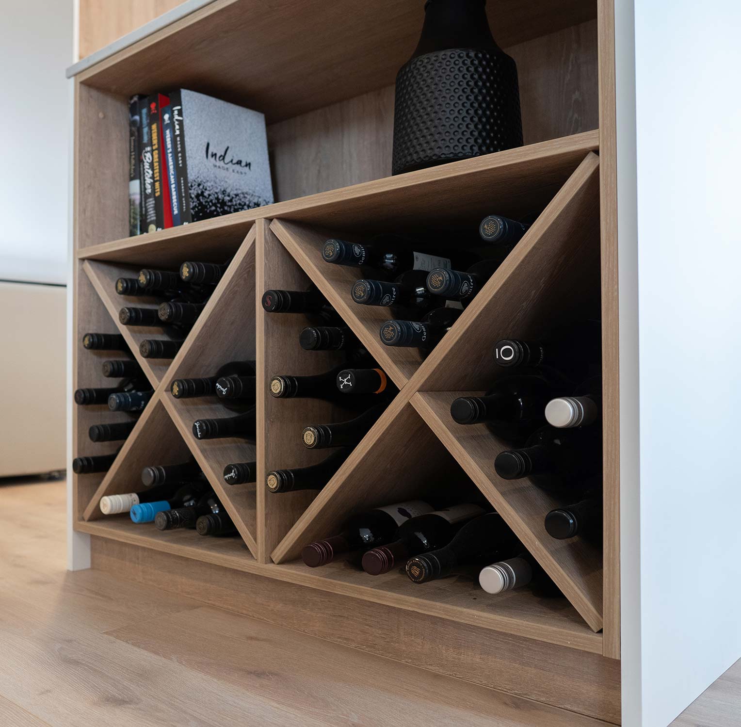 Bespoke Wine rack feature sits at the end of the Island bench in a soft timber, adding extra storage and space.