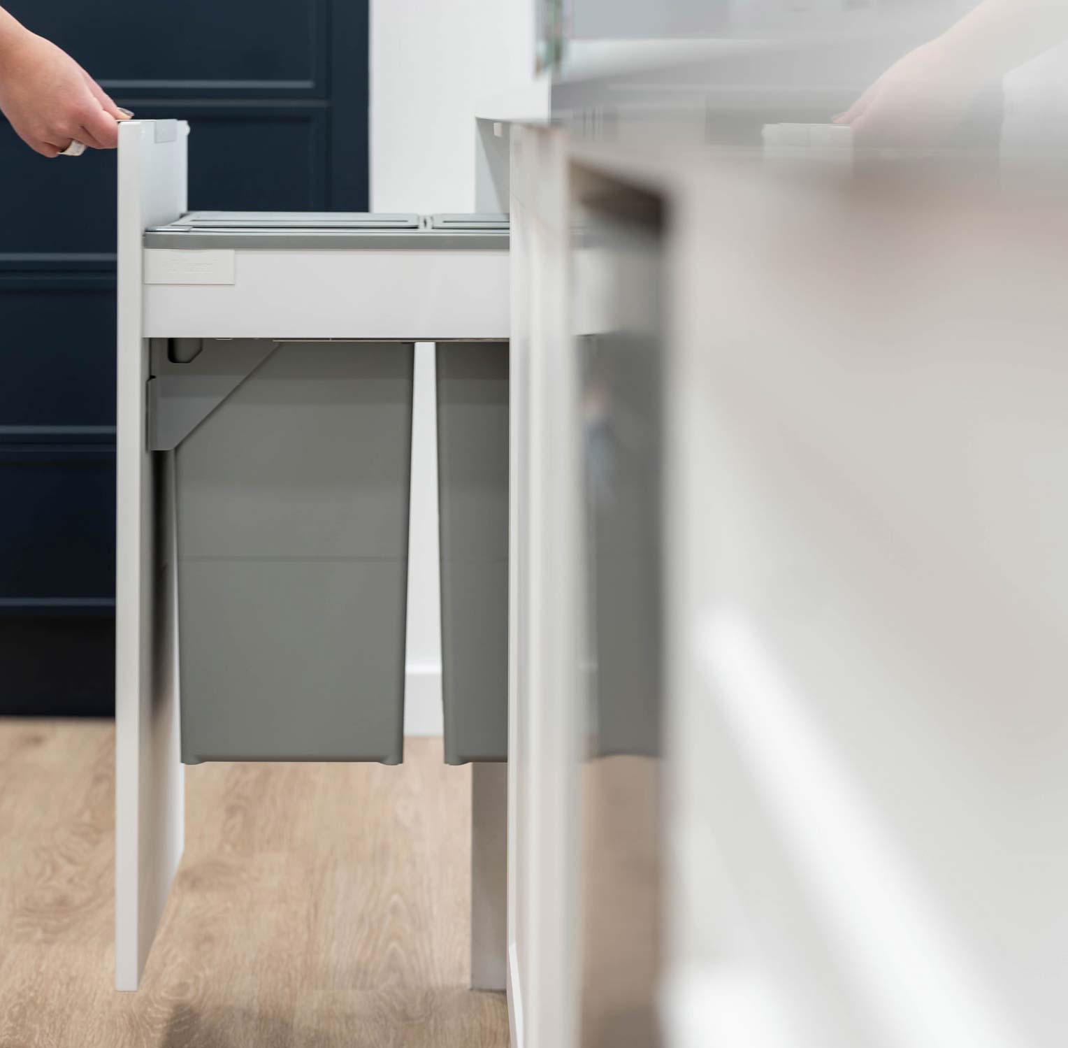 Slide out integrated Bin Cupboard in Gloss white.