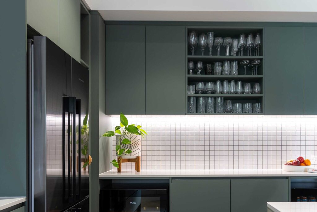 Slate green over heads with open shelving, paired with small white square tiles adding a natural feel.