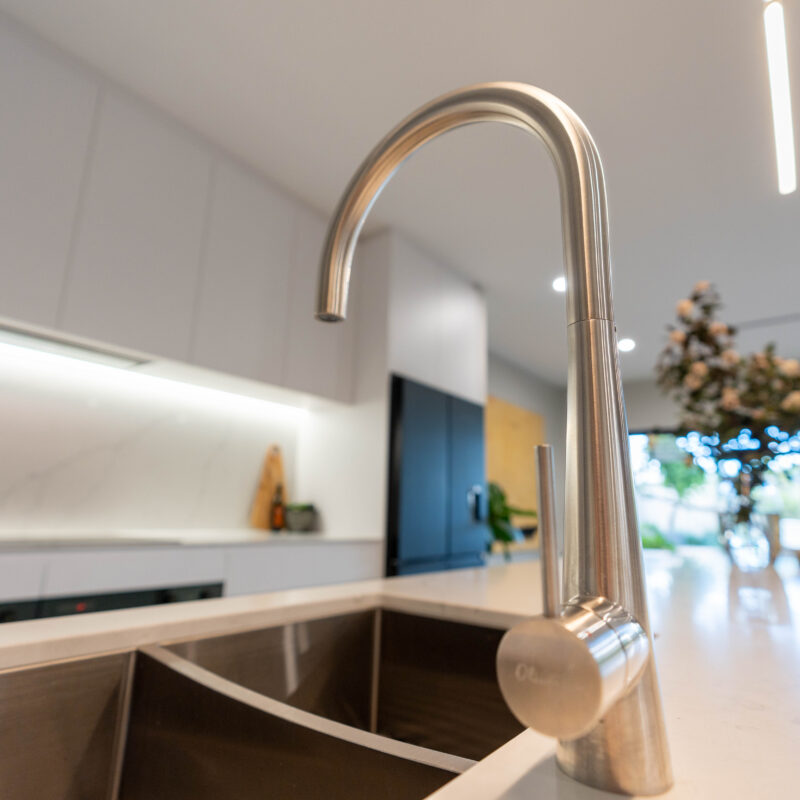 Oliveri silver tap and double bowl sink with white kitchen.