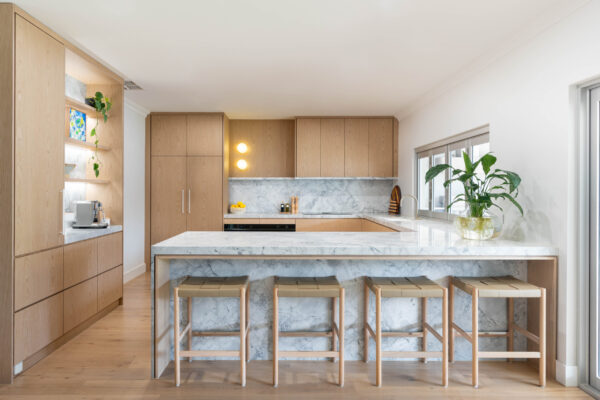 Kitchen. Delicately Organic. The detailed design of the marble on the shelving, bar back and waterfall end. Beautiful blond timber.