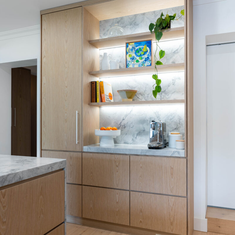 Kitchen. Delicately Organic. The detailed design of the marble on the shelving, bar back and waterfall end. Beautiful blond timber.