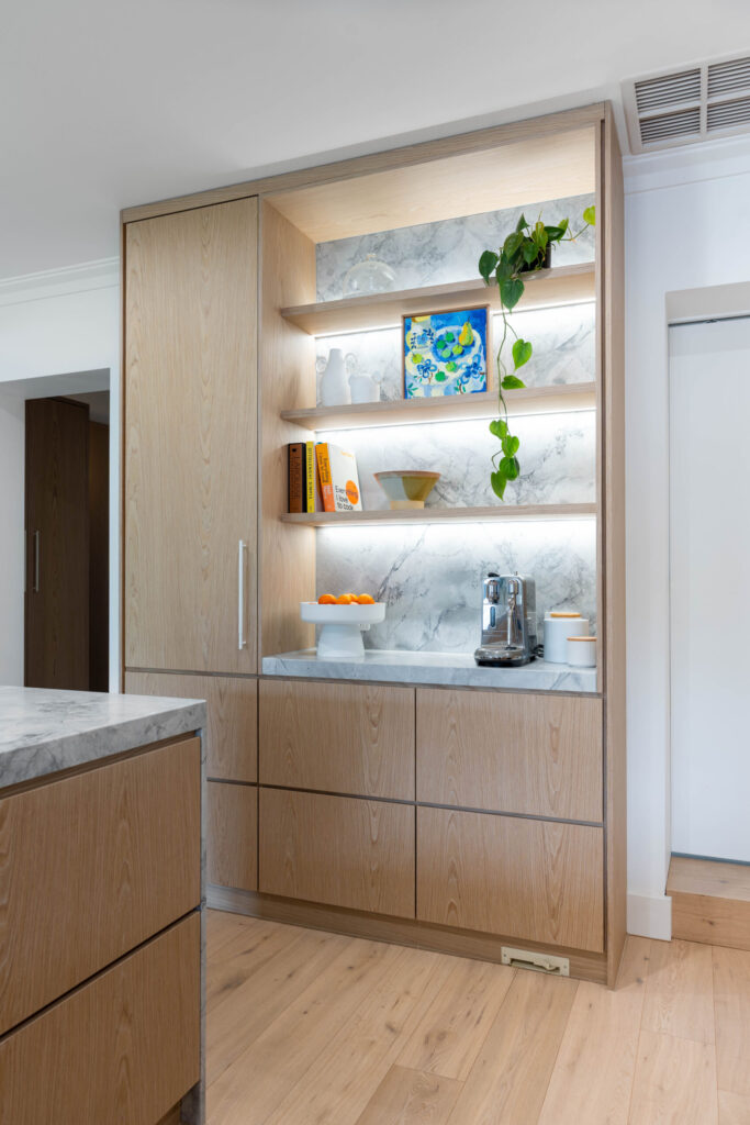 Kitchen. Delicately Organic. The detailed design of the marble on the shelving, bar back and waterfall end. Beautiful blond timber.