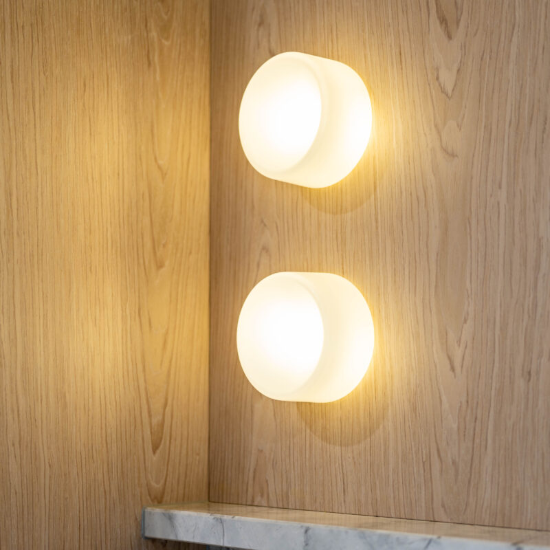 Kitchen. The detailed design of the stone on the shelving. Beautiful blond timber with round led lights featured.