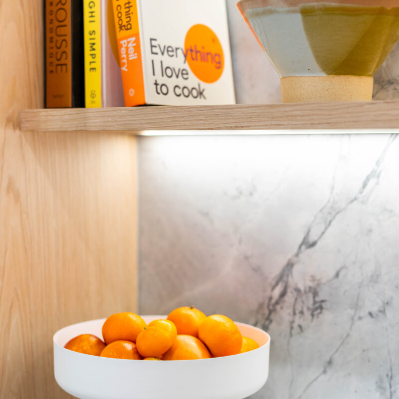 Kitchen. The detailed design of the stone on the shelving. Beautiful blond timber.