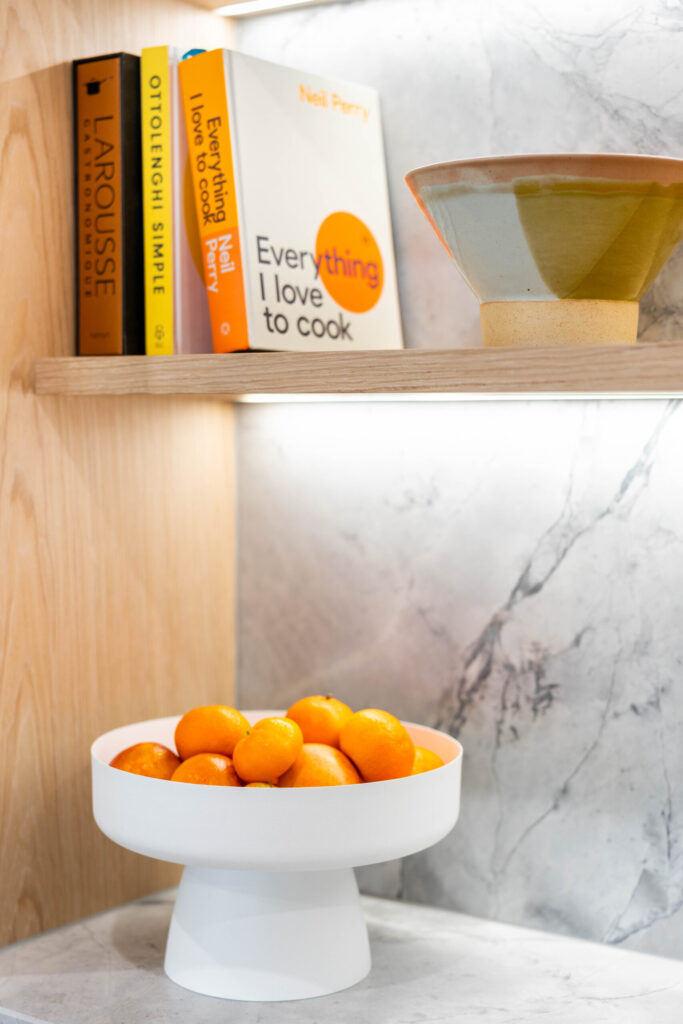 Kitchen. The detailed design of the stone on the shelving. Beautiful blond timber.