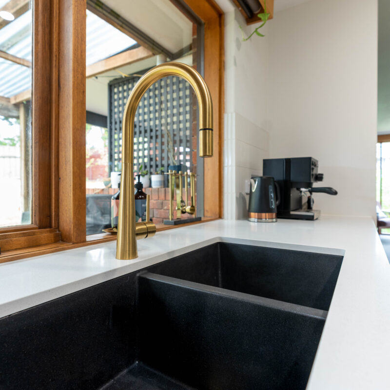 Gold Tap and gunmetal double sink. Oliveri