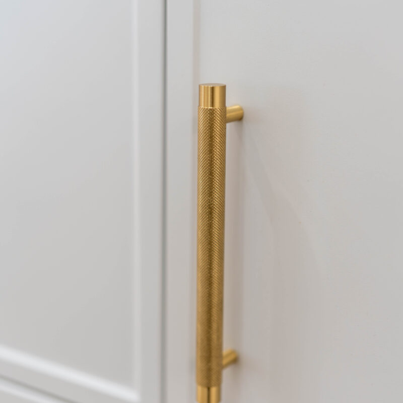 Textured Gold long handles on white grey Kiev cabinetry.