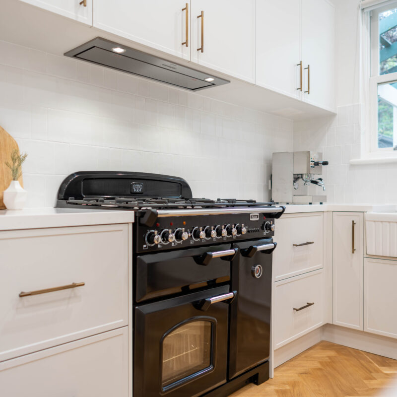 Open plan. American style Farmhouse kitchen. White grey Farquhar Suedette matte Kiev 20 L shaped kitchen with an island and statement freestanding cooker