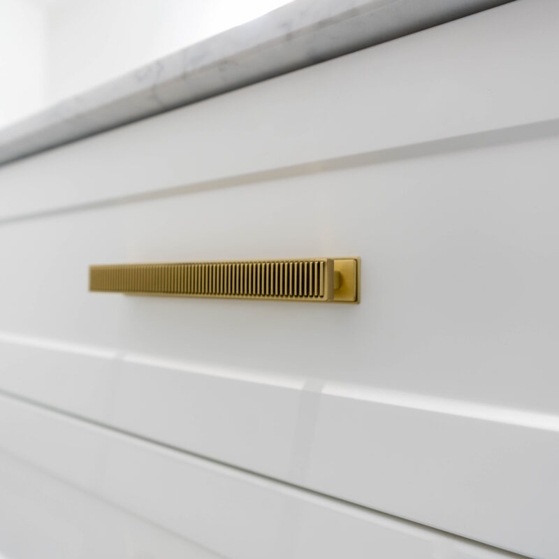 Barossa white slimline draw unit with long Gold t bar handles.