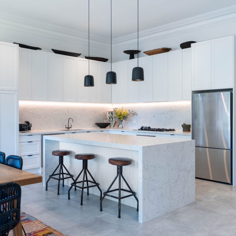 This kitchen is classic and elegant in its alignment to the architectural features of the home, with touches of industrial and contemporary design