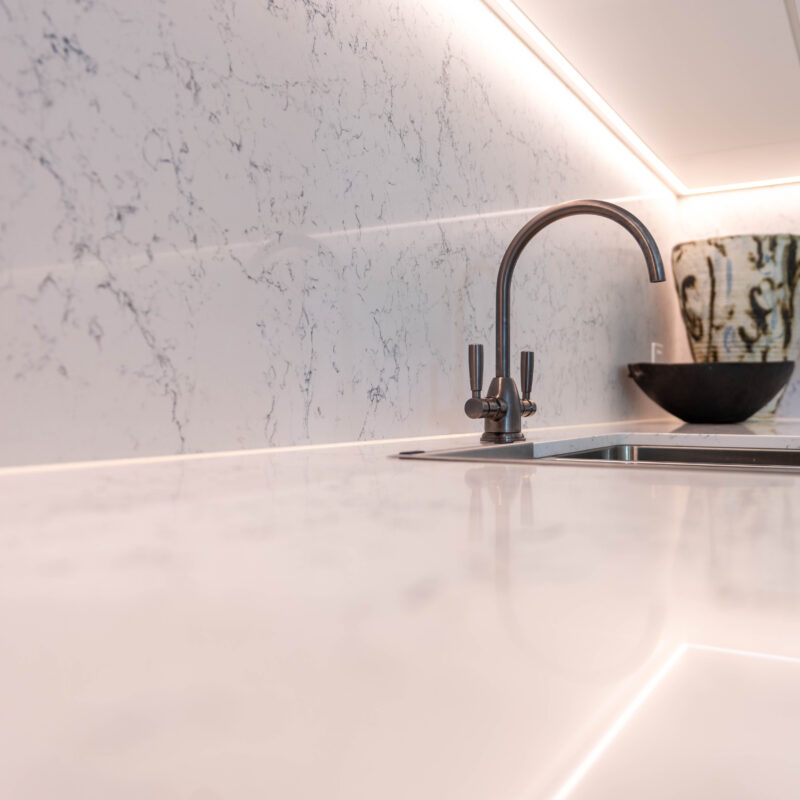 Tradtional tapware and organic grey tone stone. Stainless double bowl steel sink.