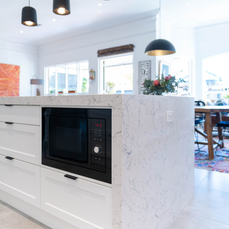A key feature is the generous island, and the versatility it provides for entertaining, meals, and storage. Grey tones and Barossa cabinetry.