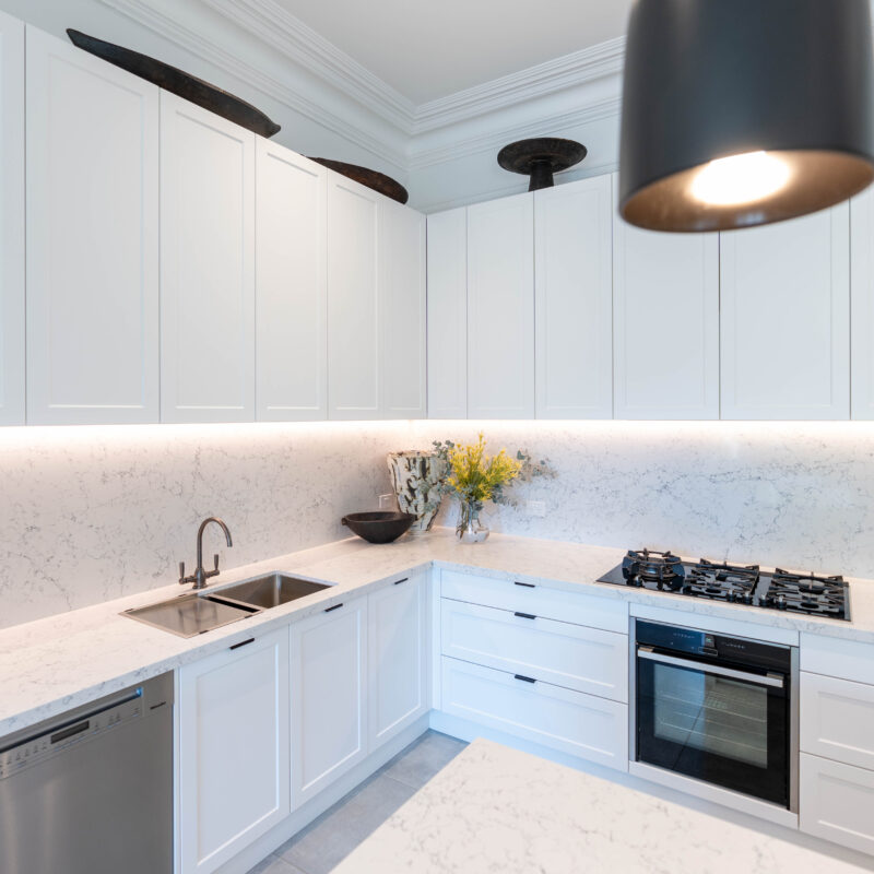 Kitchen. is a traditional shaker style profile door in white. From there, the elements that give the kitchen its layers of intricacy are added, each especially chosen to complement the art filled surroundings.