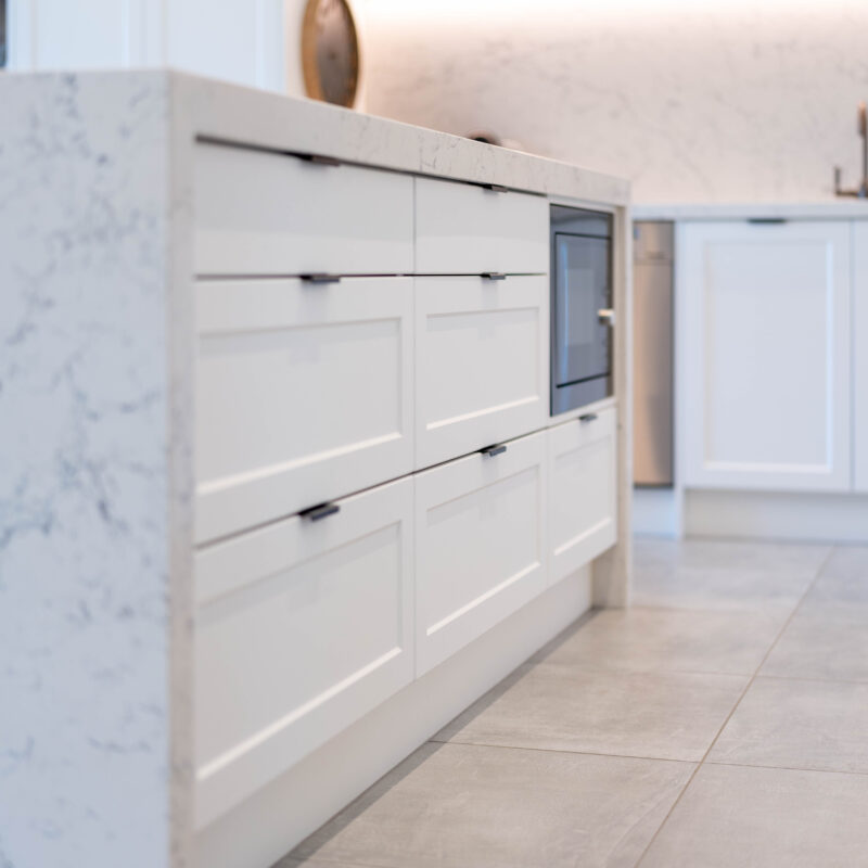 The Kitchen Island. Versatile large draws in Barossa profile cabinetry. Grey tones benchtop in zenith Carrara mist style