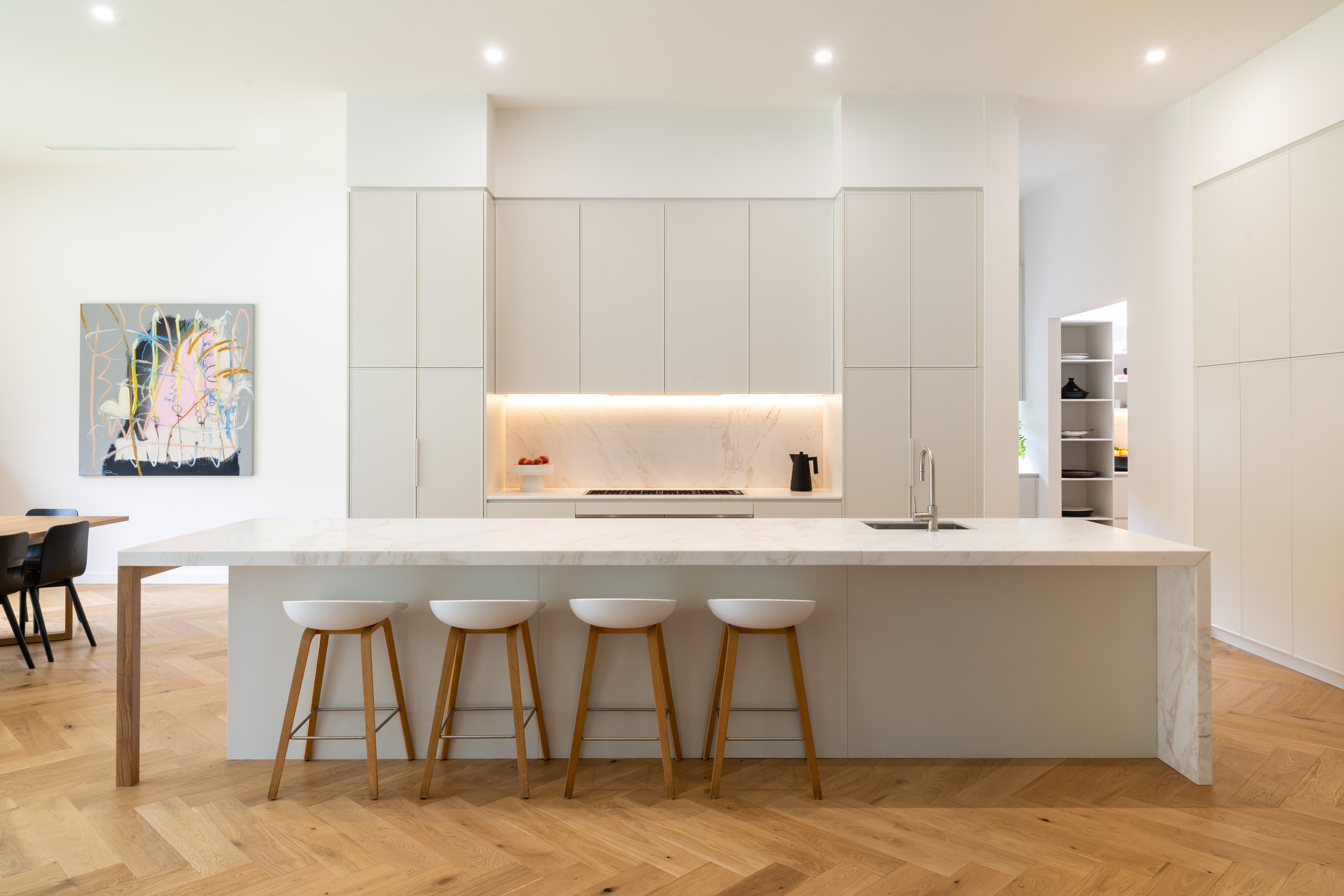 The modern Shaker. White Grey Farquhar Kiev profile Cabinetry. Lots of storage and Galley style kitchen with light marble benchtops and timber herringbone floor. Wide Open space.