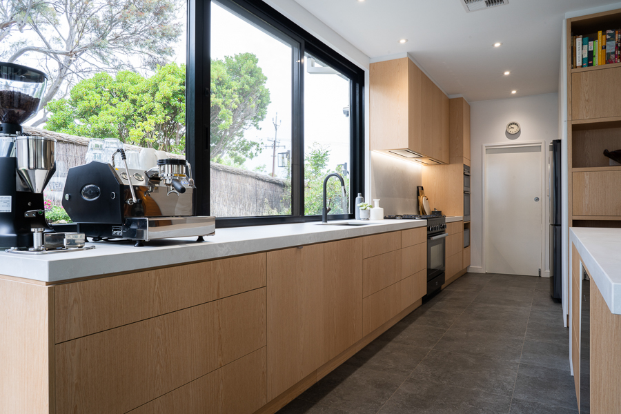 Kitchen. Sleek, Smart and social. Clean lines with timber handle free cabinetry and generous bench space. Large windows to let the light in.