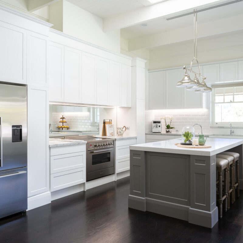 Kitchen. Hamptons style. Farquhar Barossa profile in white with white beveled edge subway tiles and large colored island and mirror splashback.