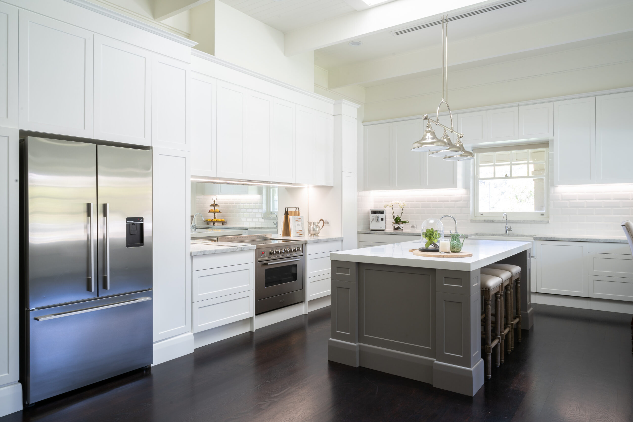 Kitchen. Hamptons style. Farquhar Barossa profile in white with white beveled edge subway tiles and large colored island and mirror splashback.