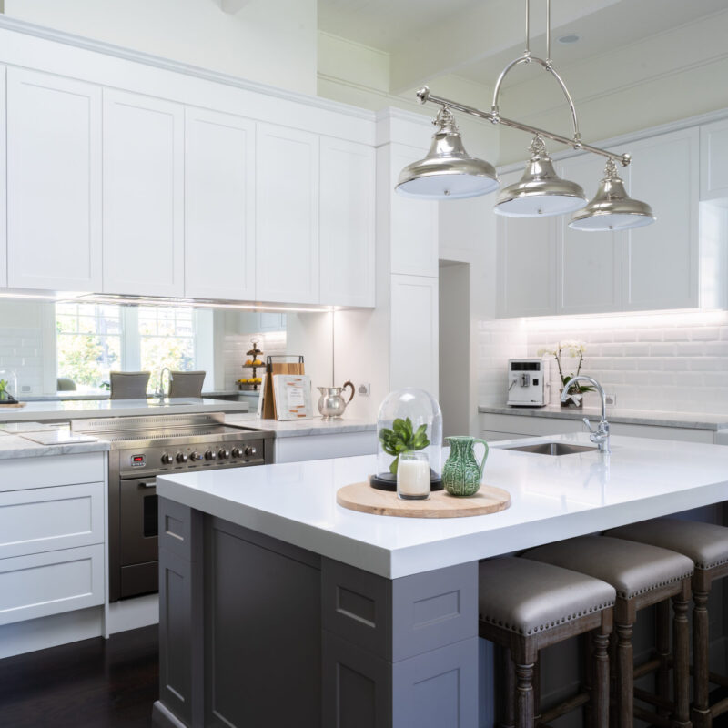 Kitchen. Hamptons style. Farquhar Barossa profile in white with white beveled edge subway tiles and large colored island and mirror splashback. Industrial and traditional.