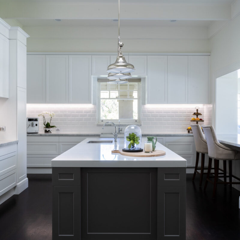 An open family kitchen space with tradtional and industrial features. Whites, greys, silvers and dark timbers. an entertaining space.