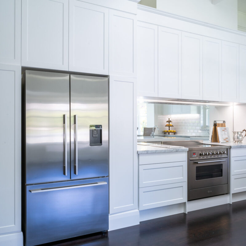 Kitchen back run of cabinetry and cooking space with 3 door fridge and stainless steel freestanding oven. Farquhar Barossa profile and dark wood timber floors.