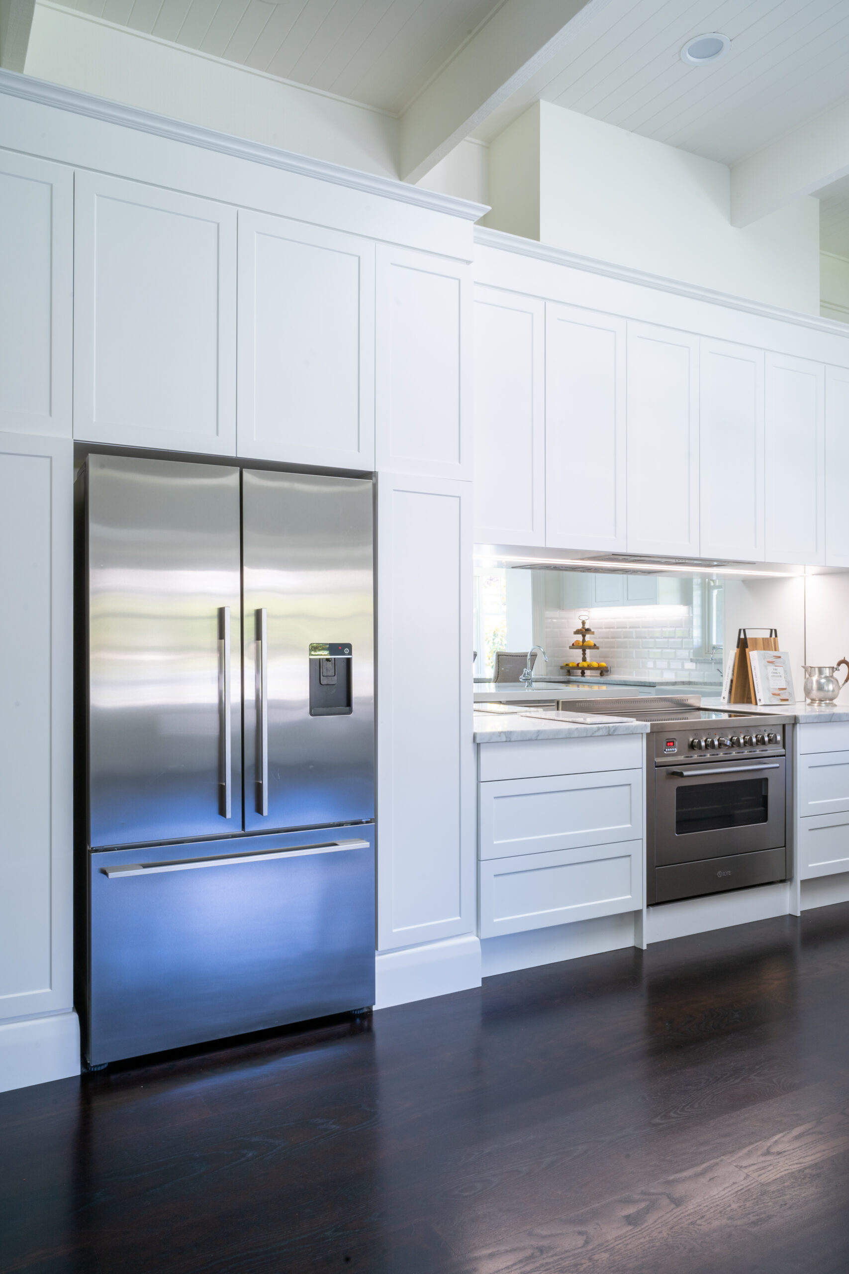 Kitchen back run of cabinetry and cooking space with 3 door fridge and stainless steel freestanding oven. Farquhar Barossa profile and dark wood timber floors.