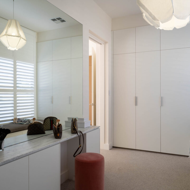 Walk in Robe space. The master walk-in robe makes getting ready a dream, fitted out with cool matte white robes on either side, a large vanity mirror and a cosy bench seat by the window with even more storage underneath.
