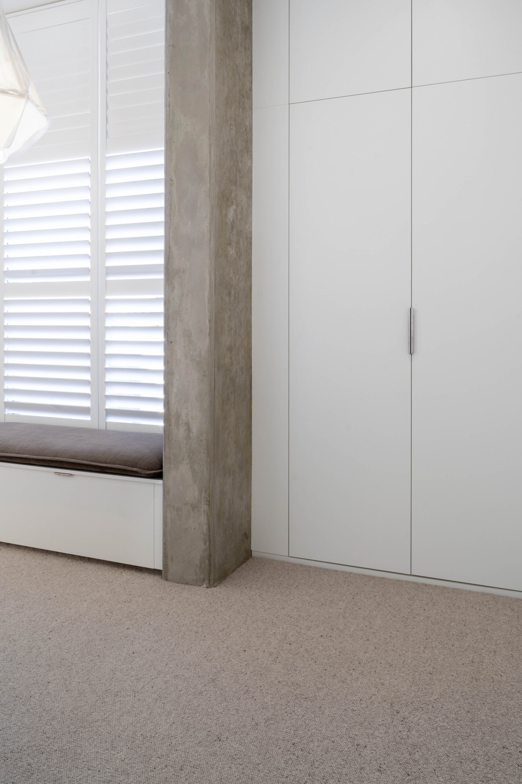 Walk in robe space. Open space with a large run of white cabinetry for storage.