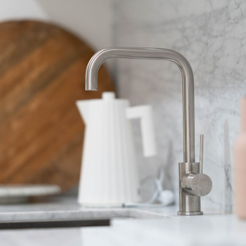 Sink and tap on benchtop, with a small kitchen display.