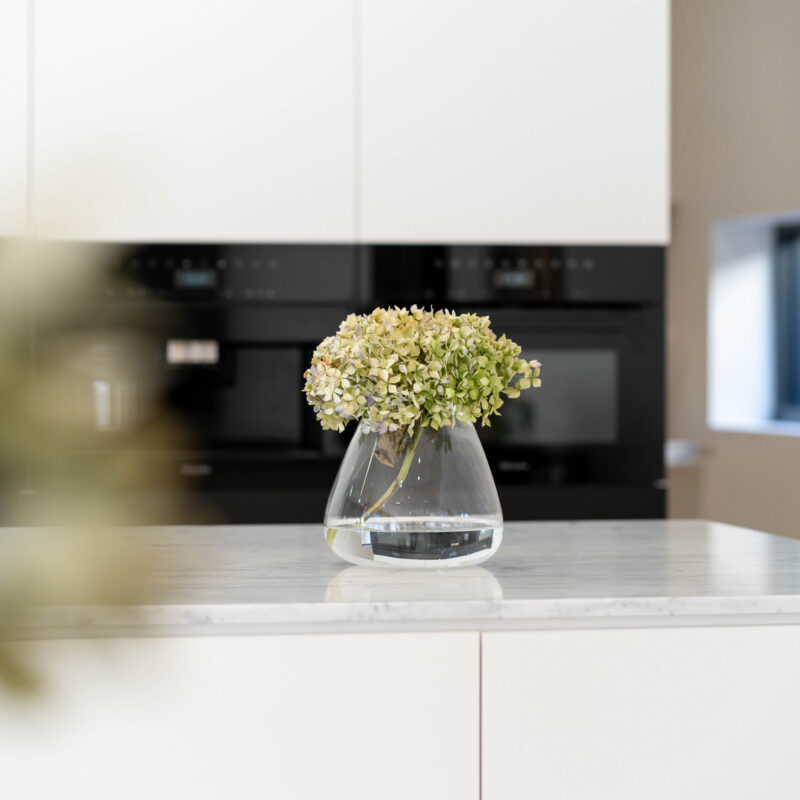 Kitchen space with vase. White kitchen.