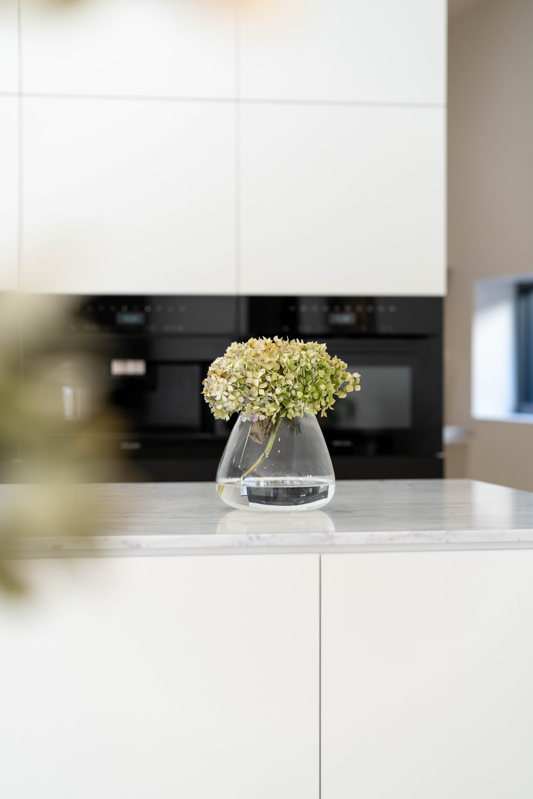 Kitchen space with vase. White kitchen.