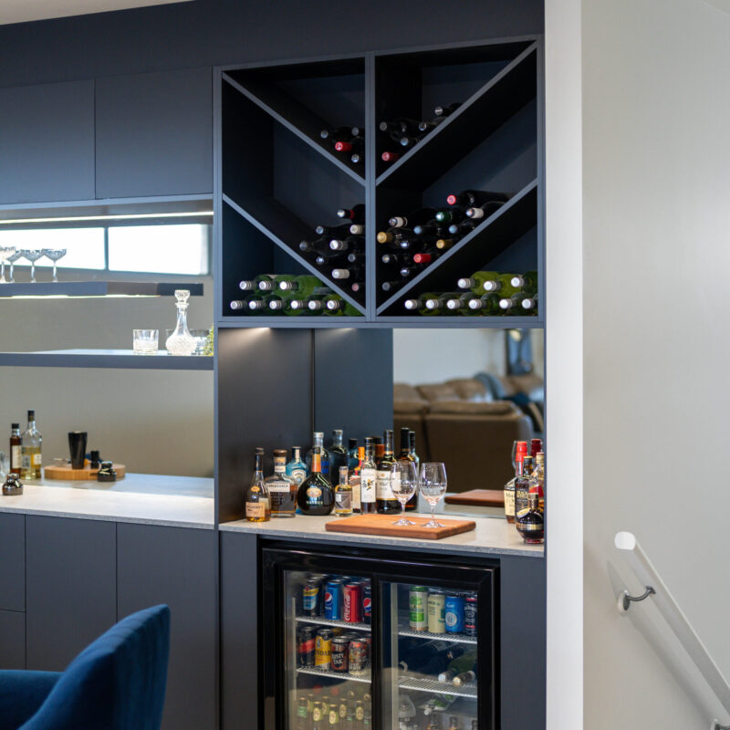 Entertainers bar in touch cabinetry, wine racks and bar fridge with bottle storage.