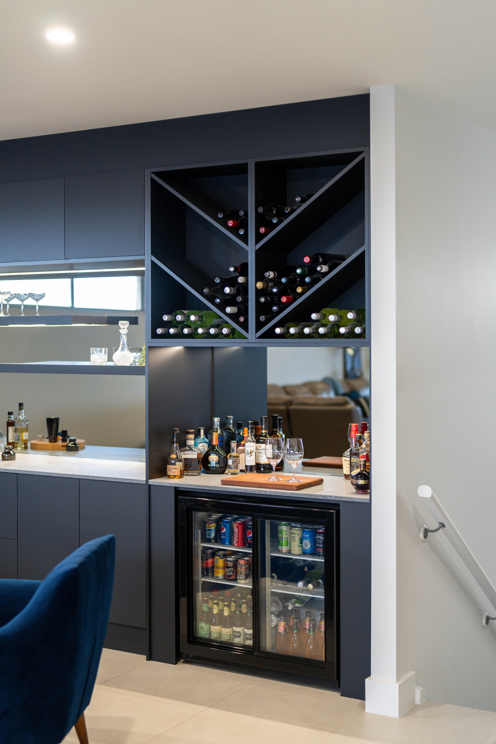 Entertainers bar in touch cabinetry, wine racks and bar fridge with bottle storage.