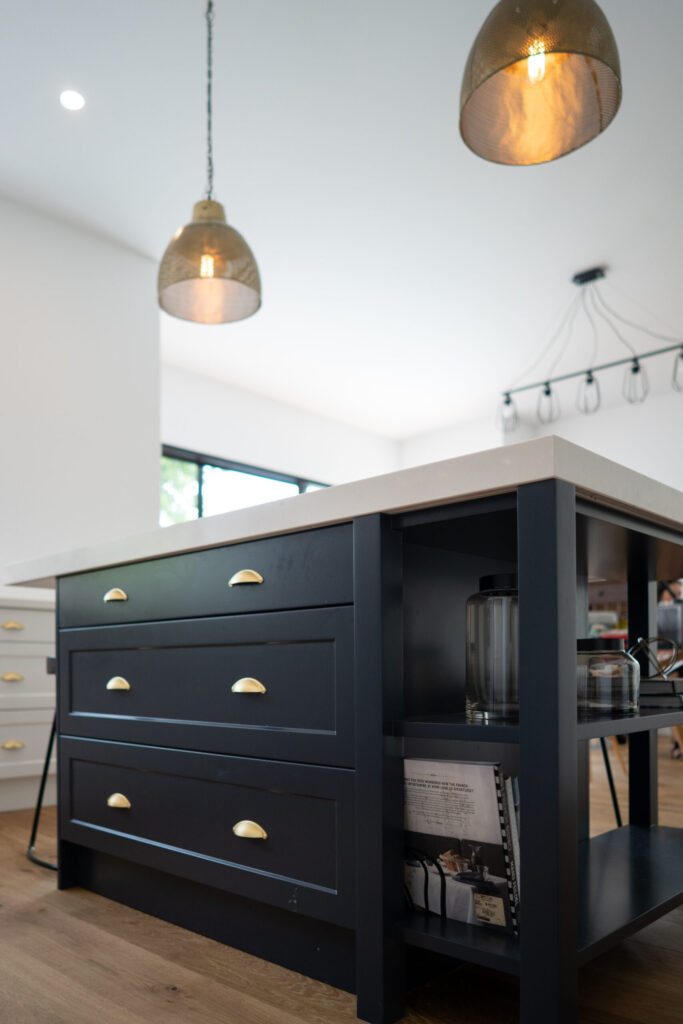 Navy island bench with three double draws and gold cup handles with side shelving.