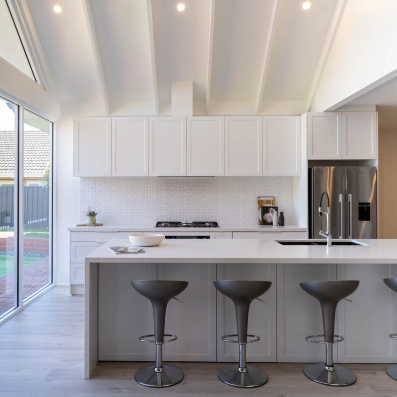 Kitchen. Bright White Cabinetry The kitchen is drenched in Farquhar's Premium White cabinetry from top to toe, further illuminating the bright, fresh and open space which has a pitched roof and huge windows allowing an abundance of natural light to flow in.
