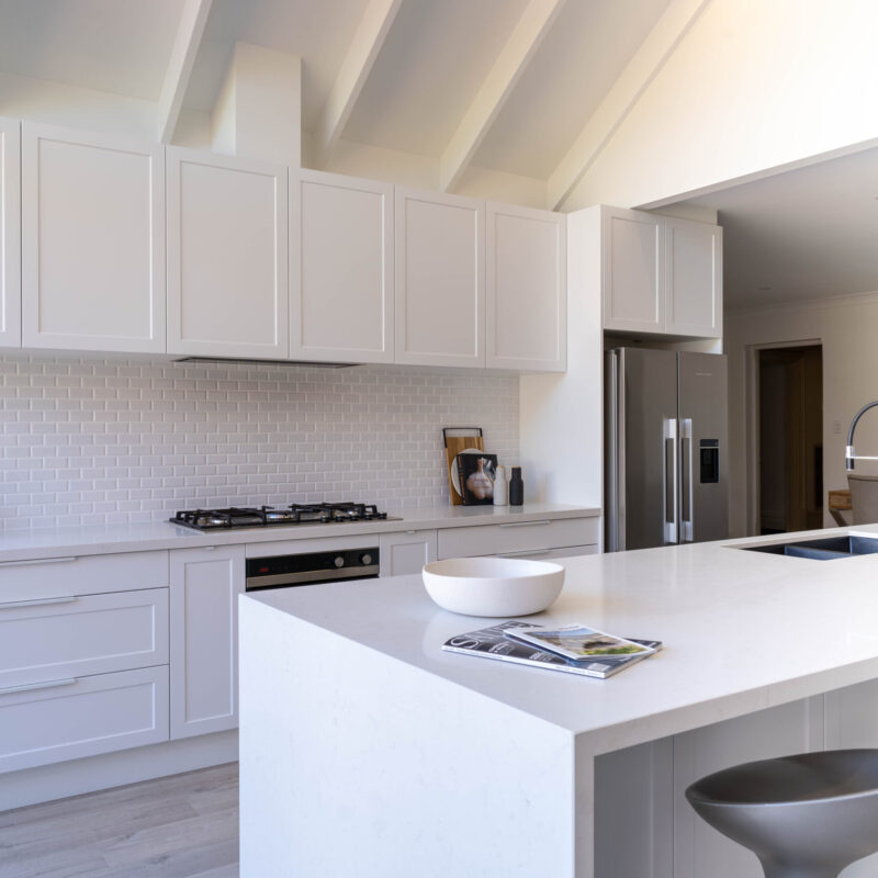 Kitchen.Bright White Cabinetry The kitchen is drenched in Farquhar's Premium White cabinetry from top to toe, further illuminating the bright, fresh and open space which has a pitched roof and huge windows allowing an abundance of natural light to flow in.