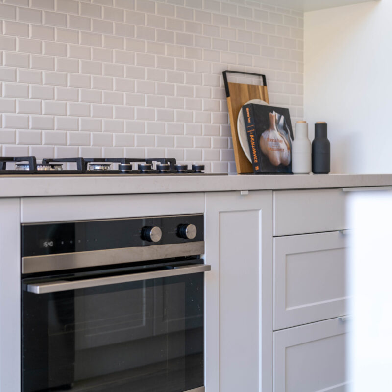 Bright White Cabinetry The kitchen is drenched in Farquhar's Premium White cabinetry from top to toe, further illuminating the bright, fresh and open space which has a pitched roof and huge windows allowing an abundance of natural light to flow in.
