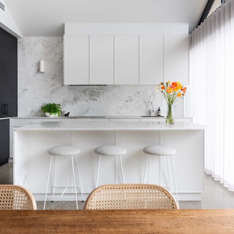 Modern monochrome black and white L shape with Island kitchen. Featuring marble benchtops and splashback.