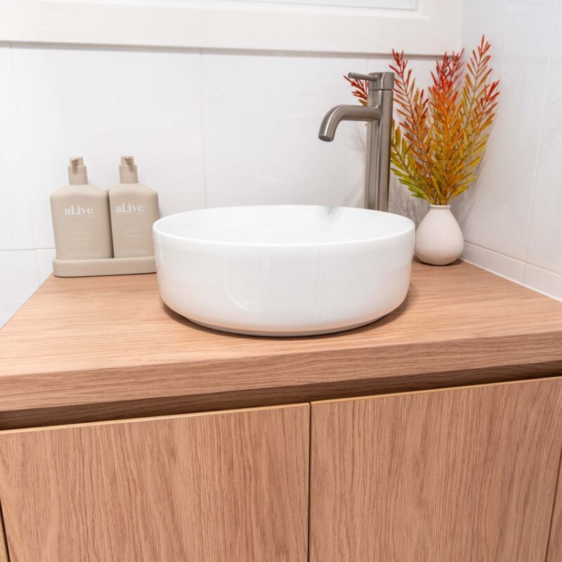 Timber laminate bathroom double door floating vanity. White top mount sink with brushed chrome mixer tap.