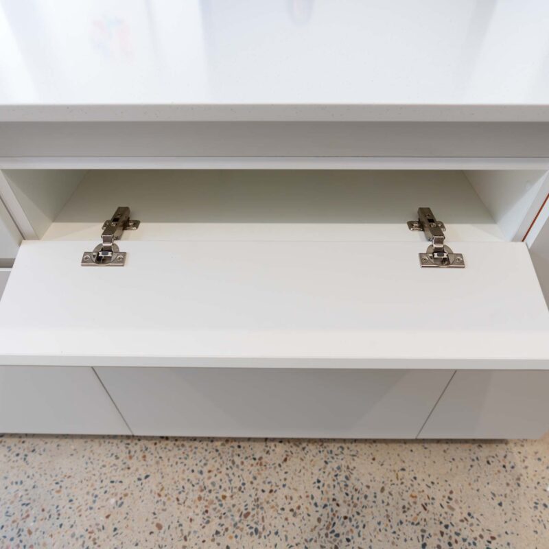 White island cabinet featuring a long rectangular horizontal hinged flap door.