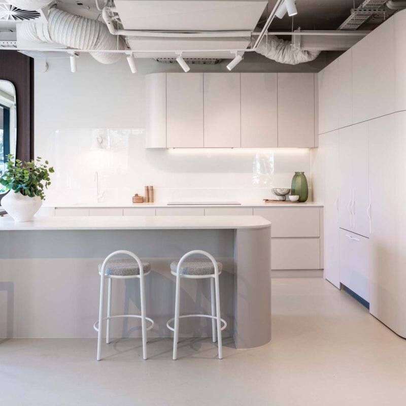Fresh and modern Farquhar kitchen display. Coolum sand laminate cabinets featuring engineered stone benchtops in Firtina.