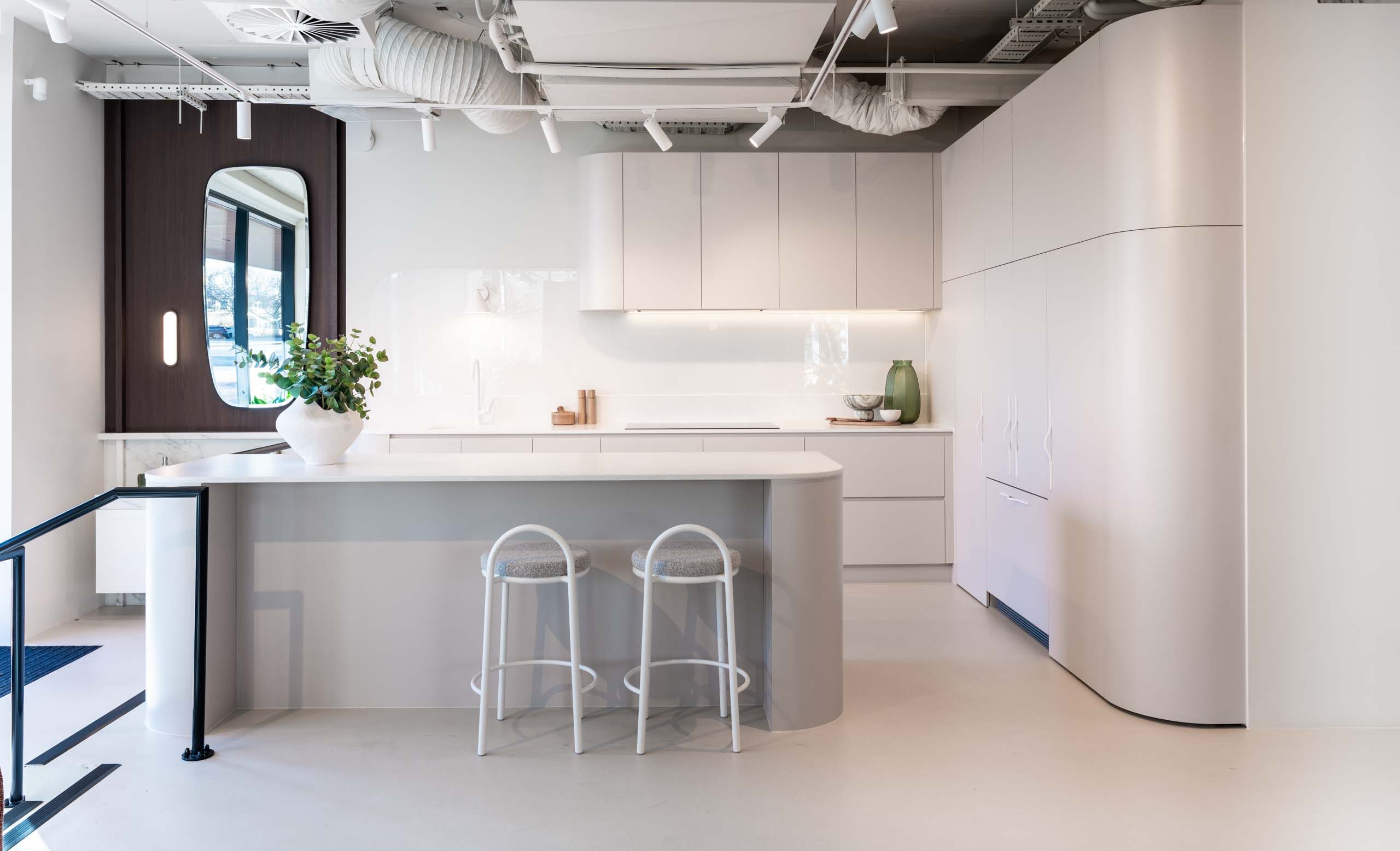 Fresh and modern Farquhar kitchen display. Coolum sand laminate cabinets featuring engineered stone benchtops in Firtina.