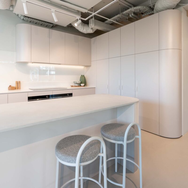 Fresh and modern Farquhar kitchen display. Coolum sand laminate cabinets featuring engineered stone benchtops in Firtina.