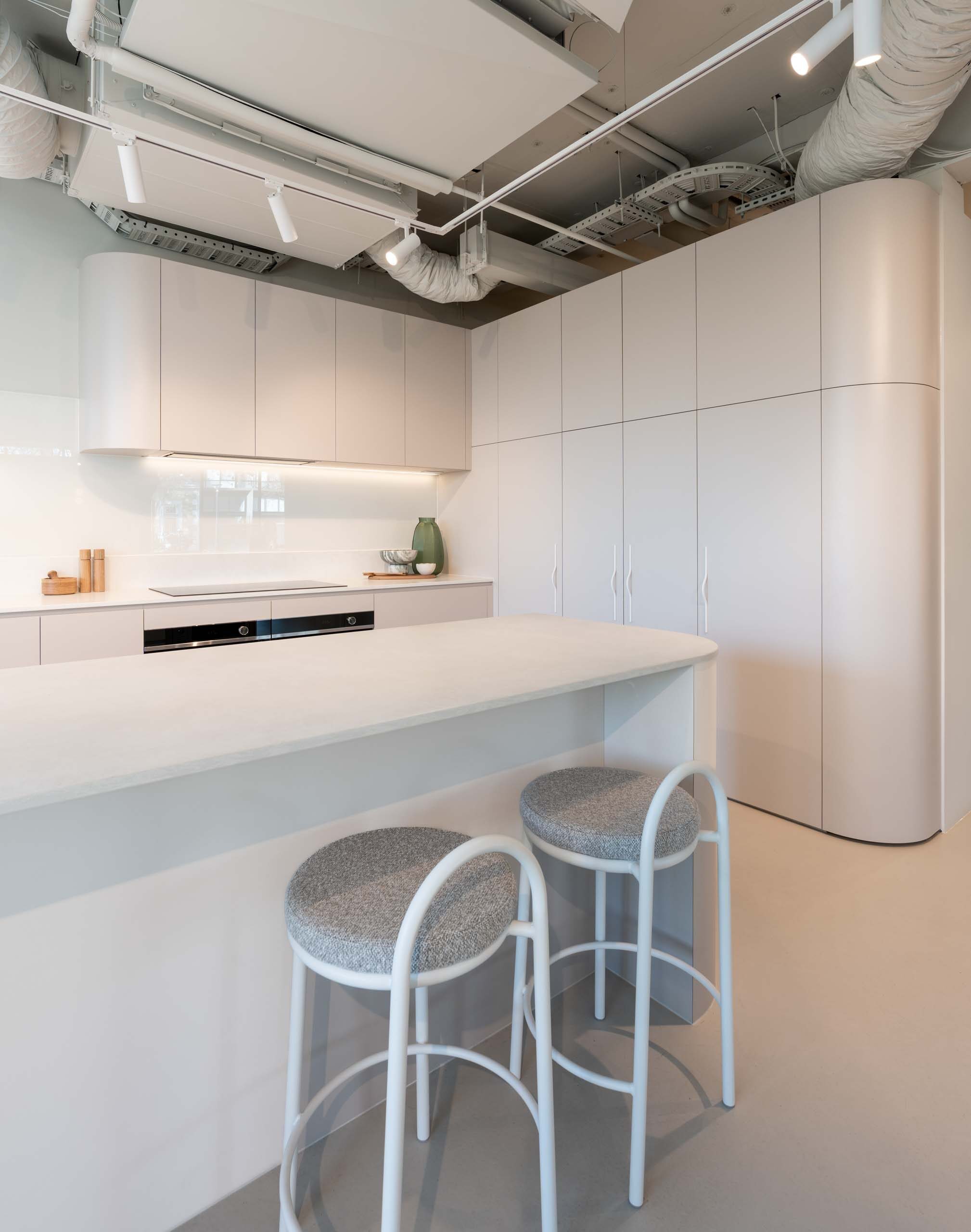 Fresh and modern Farquhar kitchen display. Coolum sand laminate cabinets featuring engineered stone benchtops in Firtina.
