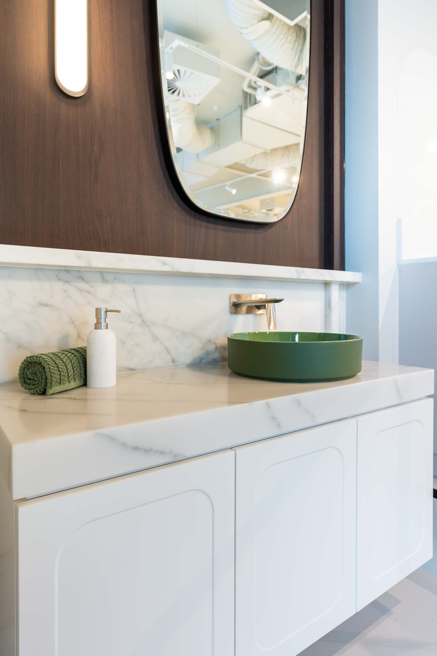 Farquhar Hutt Street showroom vanity display. Featuring white profiles door and a classic thick marble benchtop. Green top mount sink with wall mounted mixer tap.